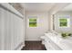 Bright bathroom with double sink vanity and views of lush greenery outside the window at 999 Bailey Rd, Woodstock, GA 30188