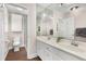 Bathroom featuring a double vanity with storage, mirrored wall, walk-in shower, and tiled flooring at 999 Bailey Rd, Woodstock, GA 30188