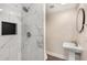 Modern bathroom featuring tiled shower with niche and a stylish pedestal sink at 999 Bailey Rd, Woodstock, GA 30188