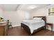 Comfortable bedroom with rustic wood bed frame and natural light at 999 Bailey Rd, Woodstock, GA 30188