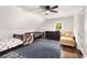 ' bedroom features a high ceiling, charming decor, hardwood floors, and comfortable furnishings at 999 Bailey Rd, Woodstock, GA 30188
