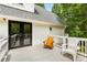 Large wooden deck area with chairs, outdoor lighting, and black doors providing a tranquil outdoor experience at 999 Bailey Rd, Woodstock, GA 30188