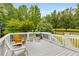Outdoor deck with gray flooring and white rails features a grill and seating creating an inviting place for relaxation at 999 Bailey Rd, Woodstock, GA 30188