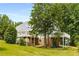 Back of house showcasing multiple balconies, lower patio, and brick exterior at 999 Bailey Rd, Woodstock, GA 30188