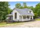 Stylish white home with a cozy porch and an attached screened-in porch at 999 Bailey Rd, Woodstock, GA 30188