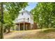 Back elevation of home with deck overlooking private wooded lot at 999 Bailey Rd, Woodstock, GA 30188