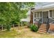 Back of home featuring screened porch, deck, and landscaped yard at 999 Bailey Rd, Woodstock, GA 30188