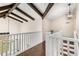 Bright hallway boasts natural light, wood floors, and wooden banister overlooking the level below at 999 Bailey Rd, Woodstock, GA 30188
