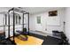Complete home gym features squat rack, weight bench and free weights at 999 Bailey Rd, Woodstock, GA 30188