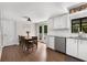 Bright kitchen and breakfast nook with stainless steel appliances, gray countertop, and adjacent french doors to the porch at 999 Bailey Rd, Woodstock, GA 30188