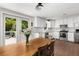 Well-lit kitchen flows to a porch with stainless appliances, breakfast nook, white cabinets, and bright windows creating an airy feel at 999 Bailey Rd, Woodstock, GA 30188