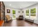 Comfortable sitting area with large windows, hardwood floors, and elegant furnishings at 999 Bailey Rd, Woodstock, GA 30188