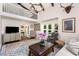 Open-concept living area with loft space, large windows, and a cozy seating arrangement at 999 Bailey Rd, Woodstock, GA 30188