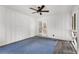 Bright and airy screened porch with white wood paneling, ceiling fan, french doors, and gray vinyl flooring, ready for relaxation at 999 Bailey Rd, Woodstock, GA 30188