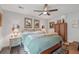 Comfortable bedroom with ceiling fan, area rug, vintage cabinet, and matching nightstand lamps at 2762 Whispering Pines Dr, Decatur, GA 30033