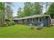Charming home exterior with well-manicured lawn, lush greenery, and inviting outdoor seating at 2762 Whispering Pines Dr, Decatur, GA 30033