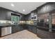 Modern kitchen boasts sleek, black cabinetry, stainless steel appliances, and plenty of counter space at 2762 Whispering Pines Dr, Decatur, GA 30033