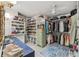 Spacious walk-in closet with ample storage, shelving, hanging racks, and beautiful blue rug at 2762 Whispering Pines Dr, Decatur, GA 30033