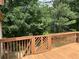View of the stained back deck with a gate to the lush surroundings at 285 Woodland St, Dallas, GA 30157