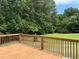 Spacious stained deck offers a great view of the backyard and surrounding trees at 285 Woodland St, Dallas, GA 30157