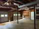 Unfinished basement with exposed ceiling, concrete floor, garage doors and access to storage at 285 Woodland St, Dallas, GA 30157