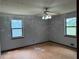 Bedroom shows a ceiling fan and two windows bringing in natural light at 285 Woodland St, Dallas, GA 30157