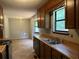 Bright kitchen featuring wood cabinets, laminate counters, and a double stainless sink at 285 Woodland St, Dallas, GA 30157