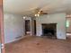 Spacious living room featuring a stone fireplace and a classic ceiling fan at 285 Woodland St, Dallas, GA 30157