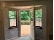 View from the interior to a private deck and lush backyard through an open door at 285 Woodland St, Dallas, GA 30157