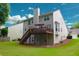 This home features a backyard with a deck, stairs, and a lush green lawn, perfect for outdoor activities at 318 Ivy Manor Nw Dr, Marietta, GA 30064