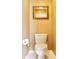 Bathroom features a toilet and mirror on a neutral colored wall at 318 Ivy Manor Nw Dr, Marietta, GA 30064