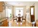 Bright breakfast nook next to the kitchen, featuring a round table, chairs, and access to backyard at 318 Ivy Manor Nw Dr, Marietta, GA 30064