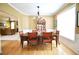 Formal dining room with chandelier, crown molding, and access to the living room at 318 Ivy Manor Nw Dr, Marietta, GA 30064