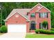 Charming brick two-story home with landscaped front yard and attached two-car garage at 318 Ivy Manor Nw Dr, Marietta, GA 30064