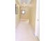 Beige carpeted hallway with light walls and a picture hanging on the wall at 318 Ivy Manor Nw Dr, Marietta, GA 30064