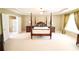 Spacious main bedroom with a four-poster bed, decorative pillows and ensuite bath at 318 Ivy Manor Nw Dr, Marietta, GA 30064