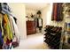 View of walk-in closet featuring custom shelving, built-in drawers, and ample storage space for clothes and accessories at 318 Ivy Manor Nw Dr, Marietta, GA 30064