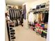 Spacious walk-in closet featuring custom shelving and ample storage space for clothes, shoes and accessories at 318 Ivy Manor Nw Dr, Marietta, GA 30064