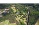 Aerial view of property showing home surrounded by lush trees, driveway and ample privacy from neighbors at 78 N Pomona Rd, Hampton, GA 30228