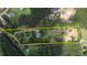 Aerial view of property with a yellow outline showing boundaries, mature trees, home and surroundings at 78 N Pomona Rd, Hampton, GA 30228