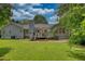 Expansive backyard with a well-maintained lawn, wooden deck, and mature trees at 78 N Pomona Rd, Hampton, GA 30228