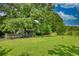 Spacious backyard featuring a chicken coop, grassy area, and ample shade under mature trees at 78 N Pomona Rd, Hampton, GA 30228