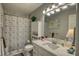 The bathroom features a large vanity and shower with gray tile and floral curtain at 78 N Pomona Rd, Hampton, GA 30228