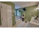 Bright bathroom featuring dual sinks, soaking tub, a houseplant, and a ladder for towel storage at 78 N Pomona Rd, Hampton, GA 30228