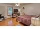 Cozy bedroom featuring hardwood floors, ceiling fan, and unique decor at 78 N Pomona Rd, Hampton, GA 30228