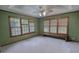 Bedroom features three bright windows and wooden window frames overlooking a lush outdoor space at 78 N Pomona Rd, Hampton, GA 30228