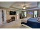 Spacious bedroom with tray ceilings, ceiling fan, sitting area, and ensuite bathroom entrance at 78 N Pomona Rd, Hampton, GA 30228