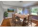 Staged dining room showcasing hardwood floors, a modern table set, and natural lighting at 78 N Pomona Rd, Hampton, GA 30228