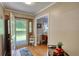 Bright entryway featuring hardwood floors, a decorative rug, and a glimpse of the front yard through a glass door at 78 N Pomona Rd, Hampton, GA 30228