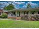 Lovely home featuring an inviting covered front porch, a brick walkway, and a beautifully landscaped yard at 78 N Pomona Rd, Hampton, GA 30228